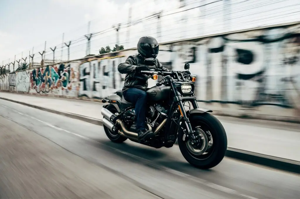 Person riding their motorcycle in full gear including helmet